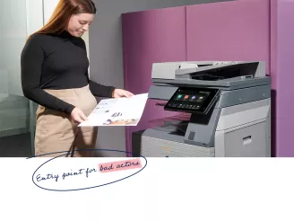 Office worker collecting print out from MFP